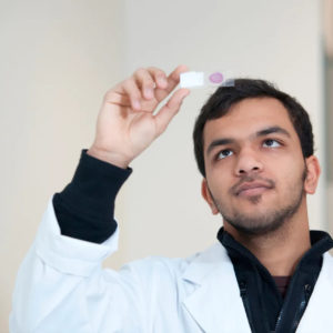 Melbourne scientist looking at sample in a university lab