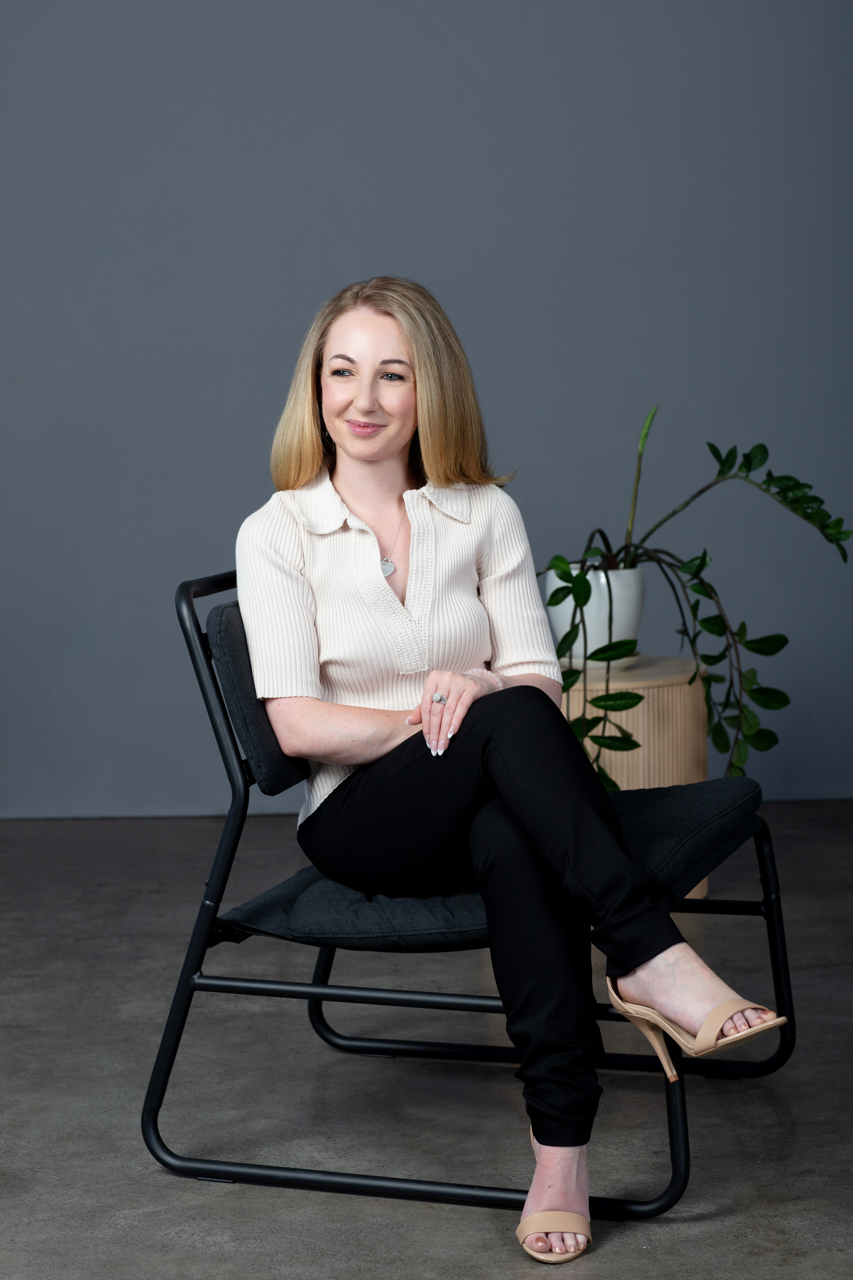 relaxed business portrait of a Melbourne health coach sitting in a chair