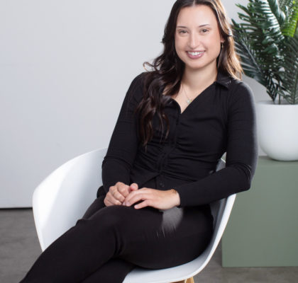 Professional Headshot of a medical professional sitting in a relaxed way in a chair