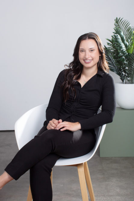 Professional Headshot of a medical professional sitting in a relaxed way in a chair